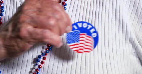 Woman Puts I Voted Sticker on Blouse Stock Footage