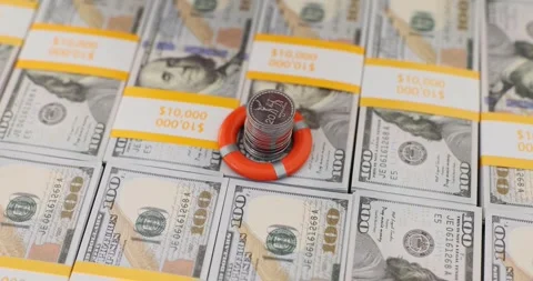 Woman puts life preserver on stack of coins on banknotes Video stock 261961644