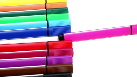 The woman puts a pink marker on the stack of colored markers. Stock Footage 157692775