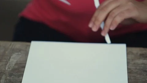The woman puts the sheet of paper in half. Stock Footage 102736133
