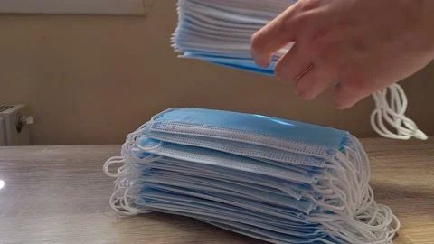 Woman Puts A Stack Of Antiviral Face Masks On The Table  스톡 동영상 151914994