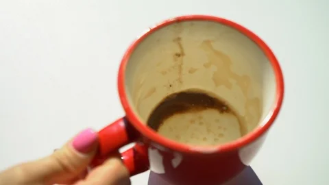 Woman puts on the table an empty cup of coffee. The coffee is over. Dirty cup. Stock Footage 105950580