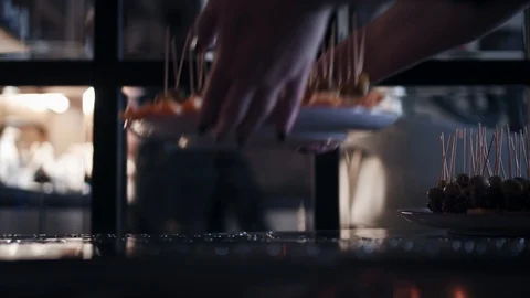 A woman puts on a table a snack for a buffet table. Hands close up view. Stock Footage 93150763