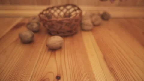 Woman puts walnuts in shells in wicker basket. Stock Footage 197315207