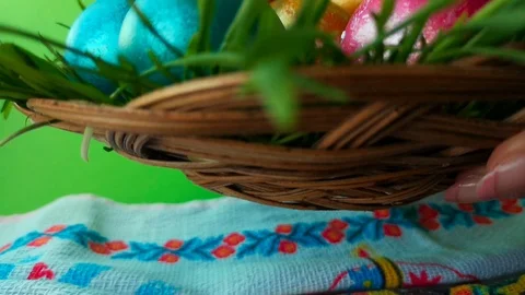 Woman puts a wicker plate with Easter eggs, green screen background Stock Footage 105926196