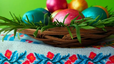 Woman puts a wicker plate with Easter eggs, green screen background. Stock Footage 105926207