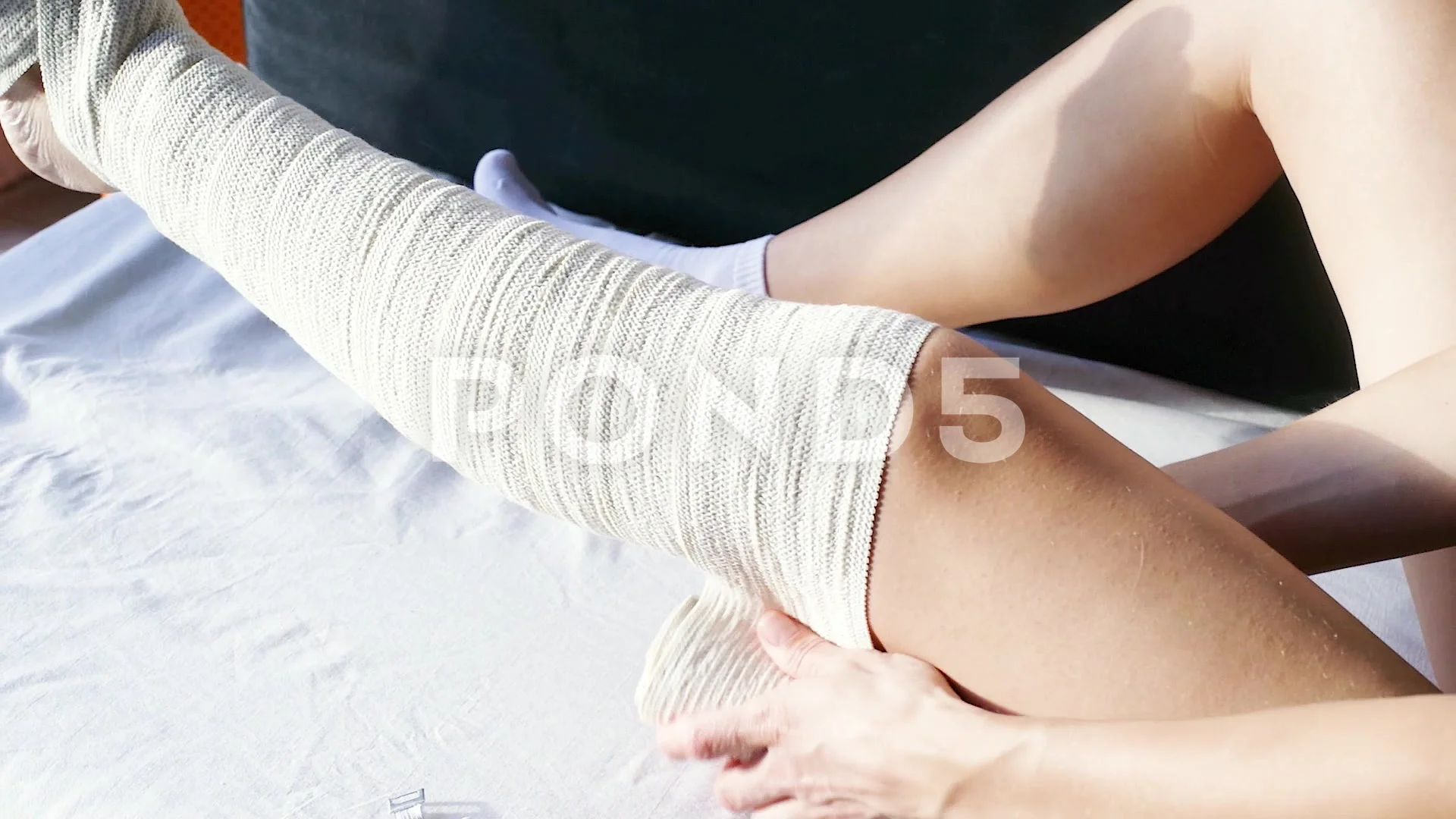 Female wearing knee orthosis or knee support brace after surgery