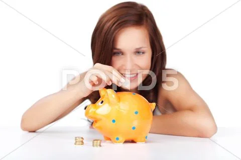 Woman putting coins in her piggy bank Stock Photos