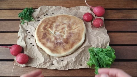 Woman putting down khachapuri on table Stock Footage 106934545