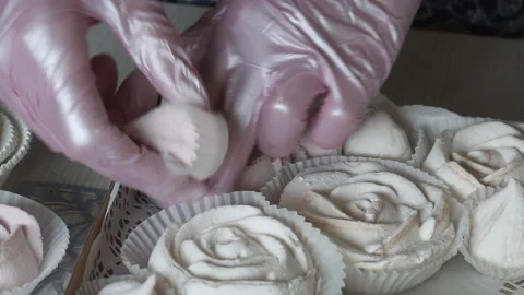 A woman is putting marshmallows in a crafted second package. Homemade marshma Stock Footage 159350667