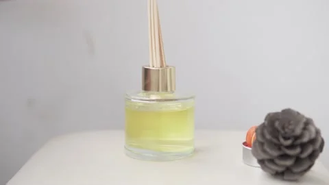 Woman putting reed diffuser on table Stock Footage 225858755