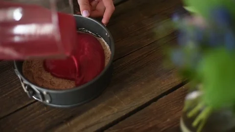Woman putting second layer of raw vegan ice cream cake Stock Footage 74660674