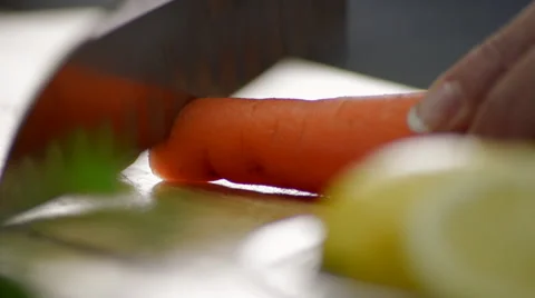 Woman Quickly Chops a Carrot on a Cutting Board Stock Footage 59346553