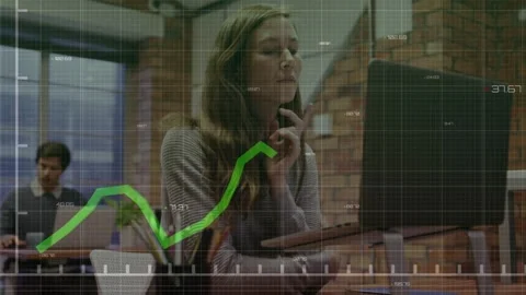 Woman at raised desk typing, causing chart overlay going up-then-down, Stock Footage 332901855