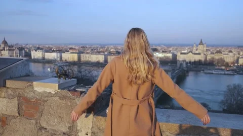 Woman raises her hands up while standing on the lookout of Budapest Video stock 142962882