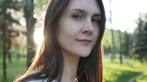 Woman in the rays of the setting sun in the forest Stock Footage 63306019