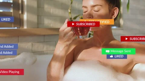 Woman reaching in bath and causing floating SUBSCRIBE badges around arm, sipping Stock Footage 333478030