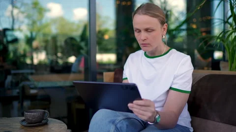 Woman reaching for coffee while working Stock Footage 313483365