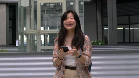 Woman react with joy while looking at her cellphone Video stock 144977937