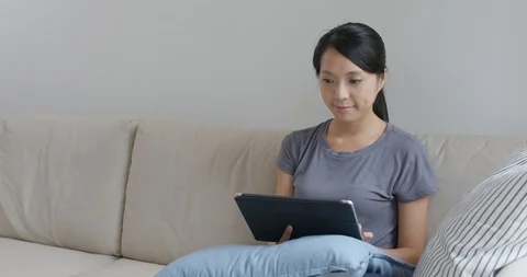 Woman read on digital tablet computer at home Video stock 107178286
