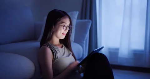 Woman read on tablet computer at home in the evening Video stock 245074356