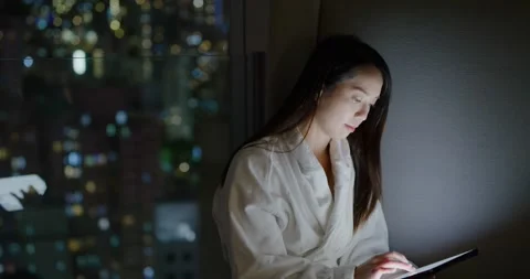 Woman read on tablet computer at night Video stock 169414162