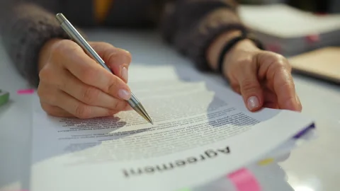 Woman reading agreement document Stock Footage 219709331