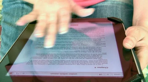 Woman reading and using an iPad tablet Stock Footage