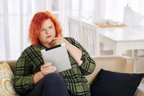 Woman reading article on tablet Stock Photos