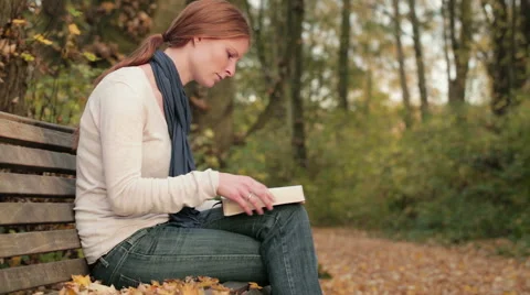 Woman Reading the Bible in a Park Stock Footage