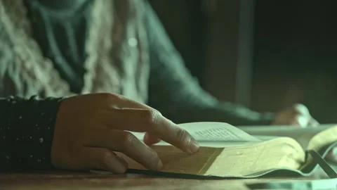 A woman reading a a book bible using hand close up 動画素材 278314510