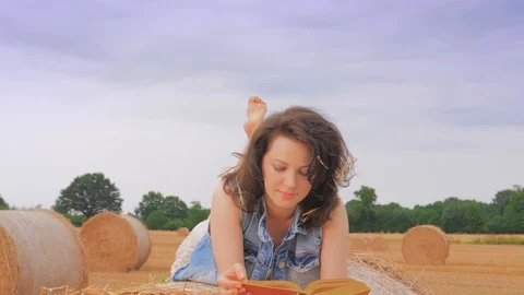 Woman reading book on haystack Video stock 101016271