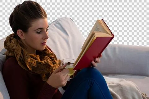 Woman reading book while having tea Stock Photos