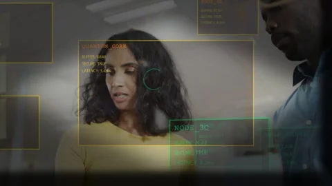 Woman reading card in tech lab, man showing orange item for review, UI boxes Stock Footage 333904763
