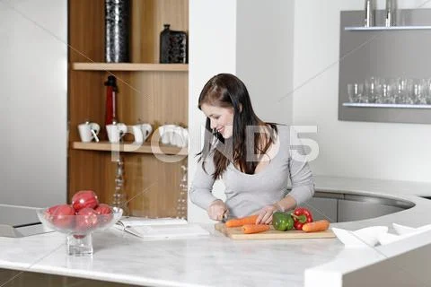 Woman reading cookery book Stock Photos