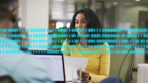 Woman reading documents in tech, binary-code overlay appearing and causing her Stock Footage 333975588