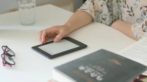 Woman Reading E-Reader and Drinking Water at Home Desk Stock-Footage 335501832