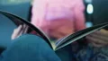 Woman reading magazine sitting in airplane cabin, spending time in waiting room HD Footage