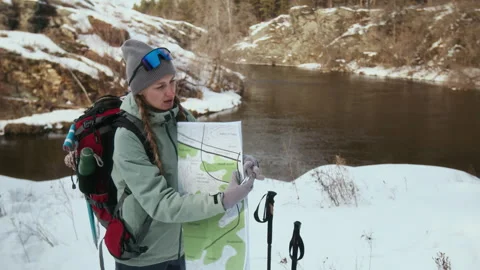 Woman Reading Map And Compass Navigating Route in Winter Scenery Stock Footage 320246495