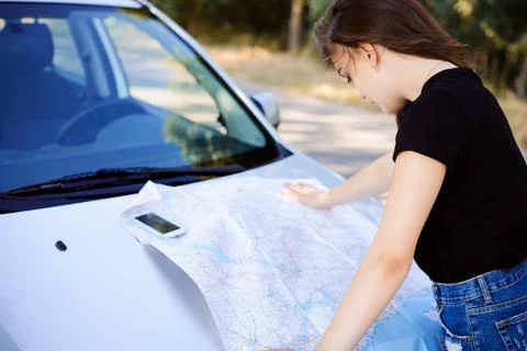 Woman reading a map Stock Photos