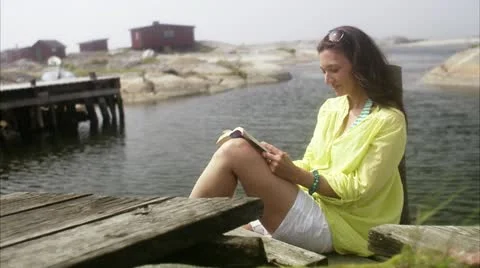 Woman reading by the sea Stock Footage 11340053