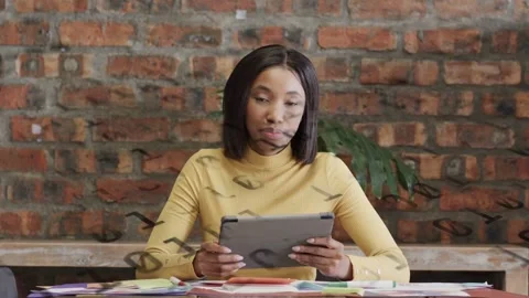 Woman reading tablet, tapping and advancing education notes, shadow overlays Stock Footage 333689186