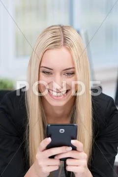 Woman reading a text message on her mobile Stock Photos