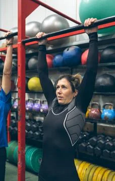 Woman ready to do pull ups in the box Stock Photos