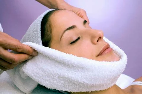 Woman receiving face treatment, eyes closed, close-up Stock Photos