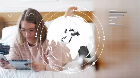 Woman reclining on bed with tablet, tapping phone causing spinning holo globe Stock Footage 333774767