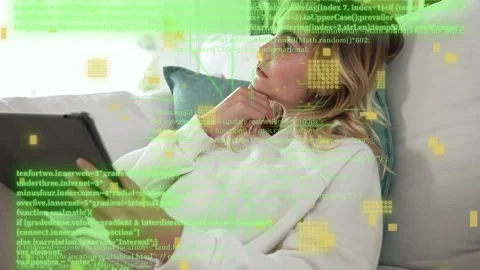 Woman reclining on white sofa, using tablet and initiating tech code overlays, Stock Footage 333553048
