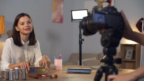 Woman Recording Makeup Tutorial for Blog Video stock 99238915