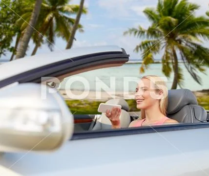 Woman recording voice on smartphone at car Stock Photos