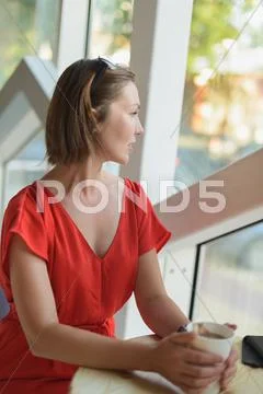 Woman in a red dress at cafe Stock Photos